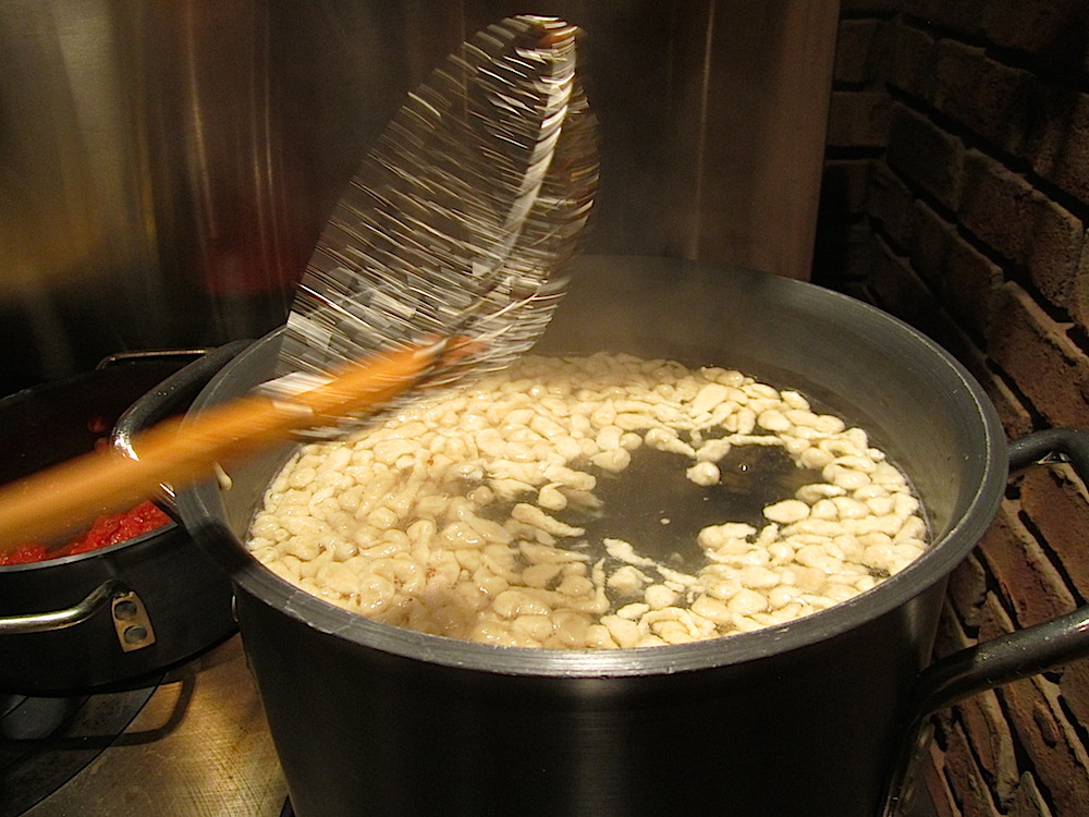 Spaetzle coming together in simmering water.