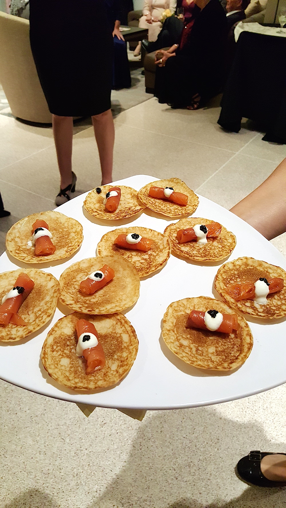 Smoked salmon blinis were being passed.