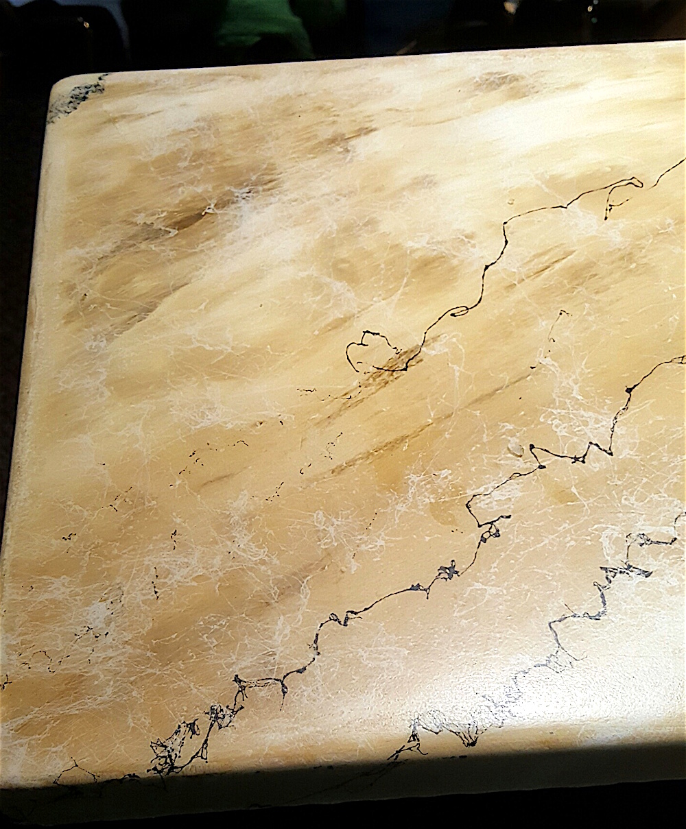 The beautiful table tops look like marble, but they are not. They are concrete. They were created by Eugenia Almeida, a Knoxville artisan originally from Argentina.