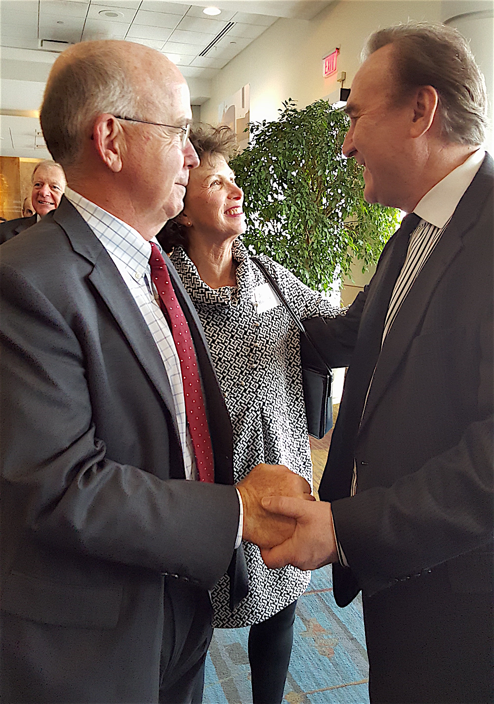 Spezia, right, greets Ted Flickinger and Julie Howard.