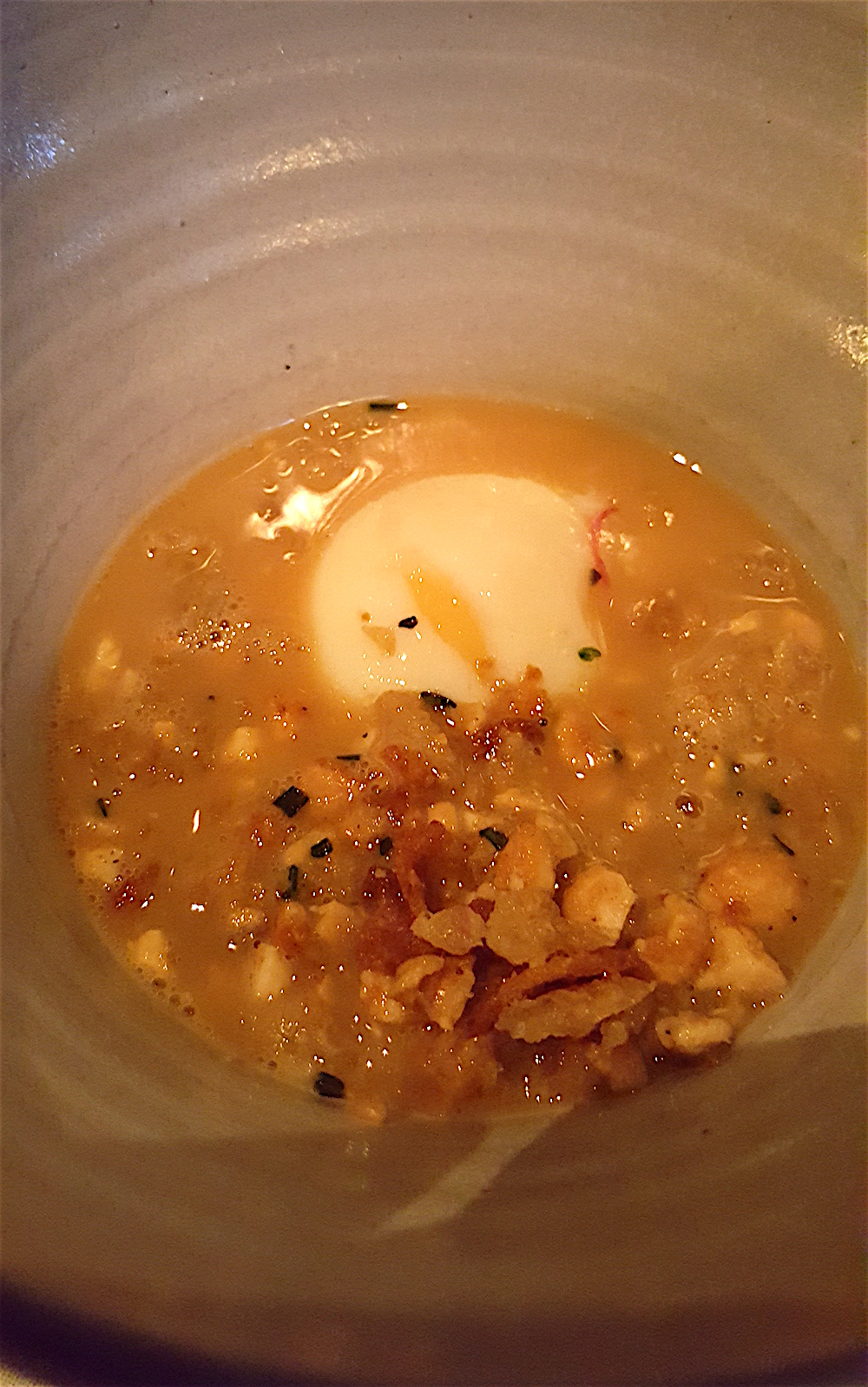 Slow cooked farm egg in a smoked chicken broth with radishes, grits and peanuts. This was as delicious as it looks.