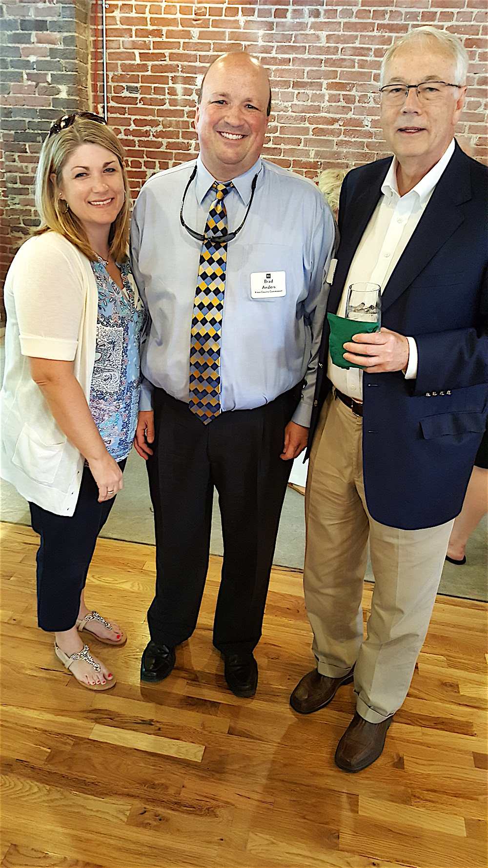 Jennifer and County Commissioner Brad Anders with Alan Carmichael, right.