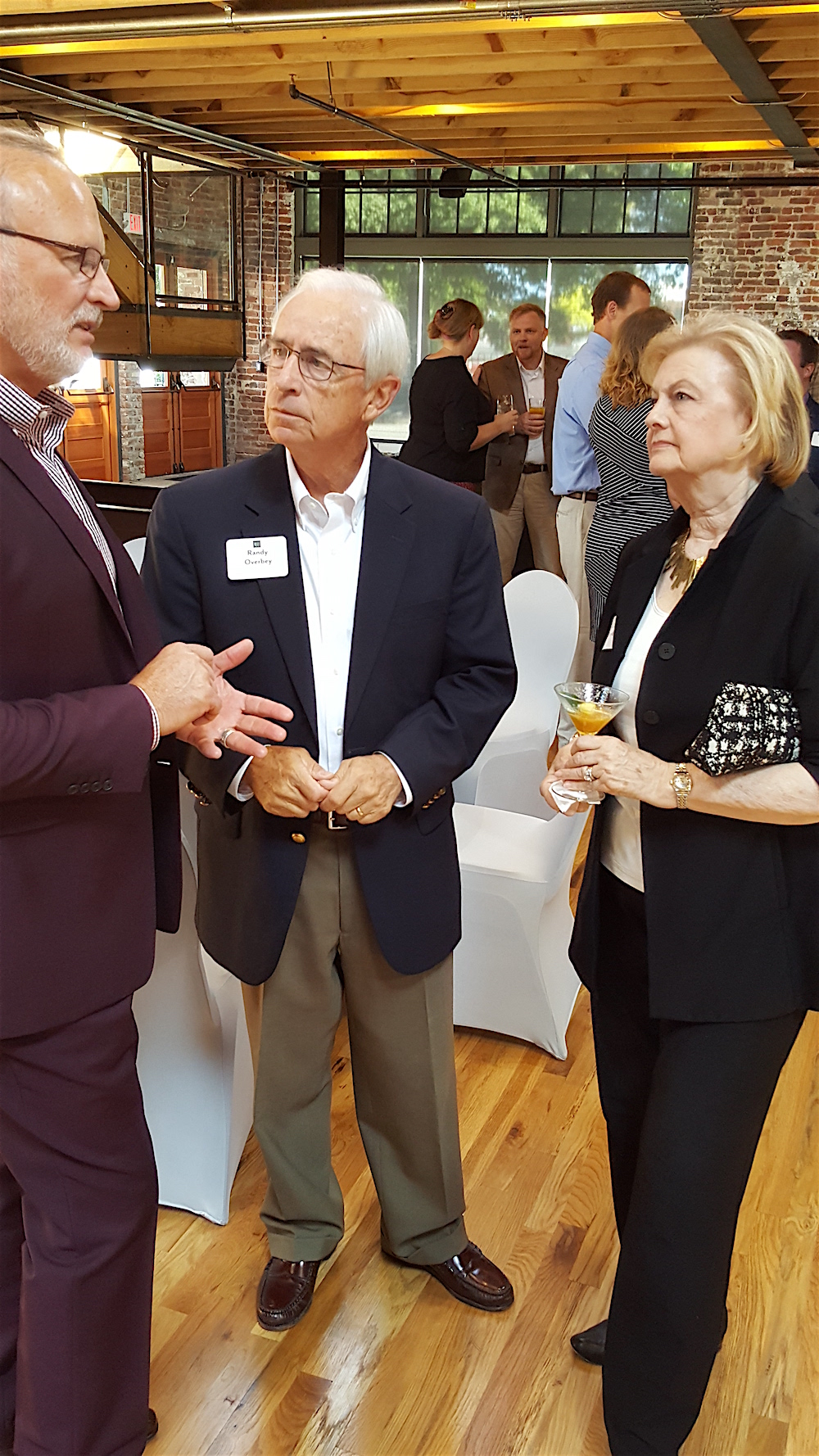 Randy and Carol Overbey discuss Regas Square with Doug White, left.