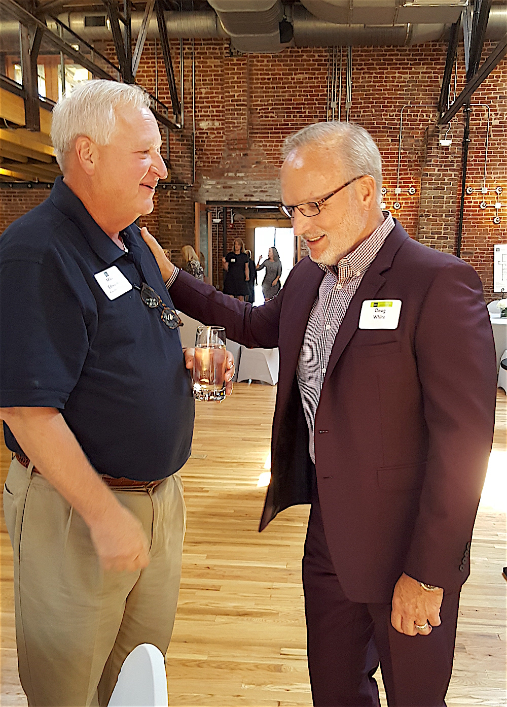 Knoxville Chamber President and CEO Mike Edwards, left, chats about the project with Doug White.