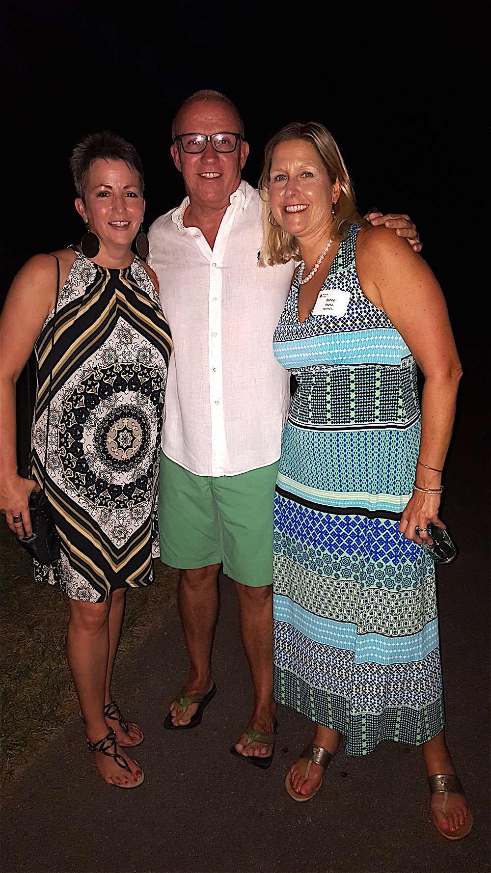 Host Eddie Mannis with his friends Sherry Jenkins, left, and Renee Repka on the lawn of his Kingston Pike home.