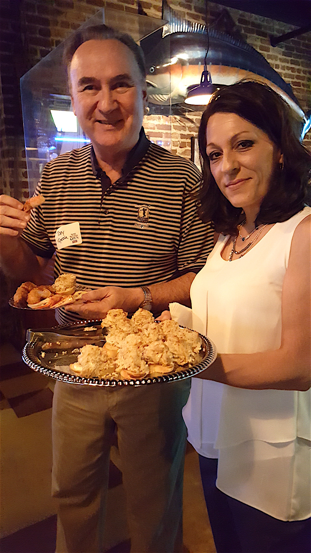 Covenant Health CEO Emeritus Tony Spezia enjoyed the crab cake appetizers at the party, which was held at Chesapeake's downtown.