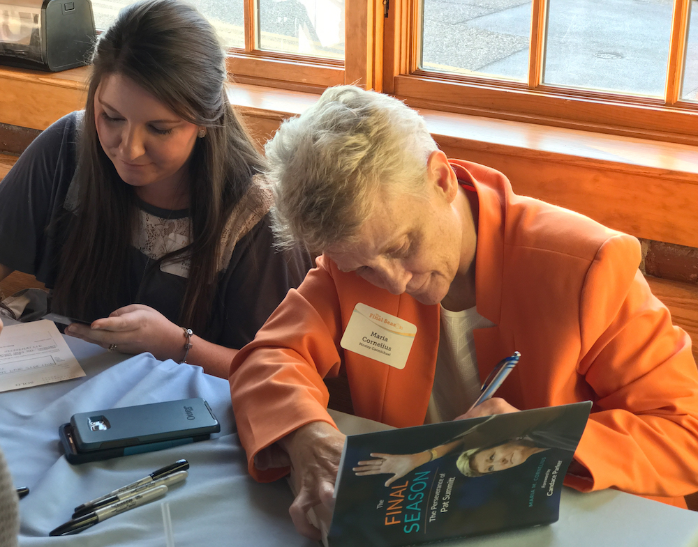 Then Maria got to work signing books. That's Linsey Perry from UT Press with Maria.